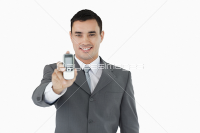Smiling businessman showing his phone