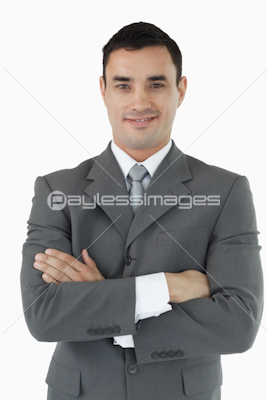 Smiling businessman with his arms folded