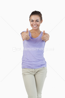 Smiling young female giving thumbs up