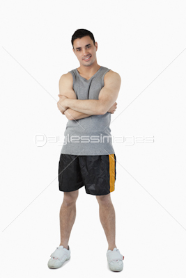 Sporty young male with arms folded