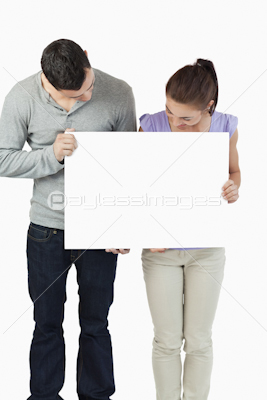 Young couple holding banner together and looking down