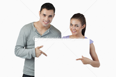 Young couple pointing at banner in front of them