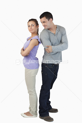 Young couple standing back-to-back to each other