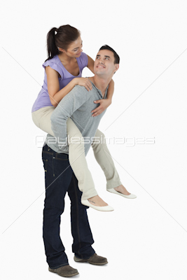 Young female carried piggyback by her boyfriend