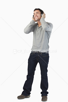 Young male listening to music with headphones on