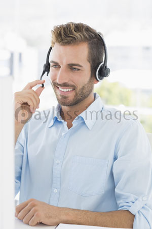 A close-up of an accidental young man with the computer which a headset uses