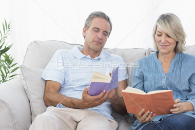 Couple relaxing and listening to music on the couch