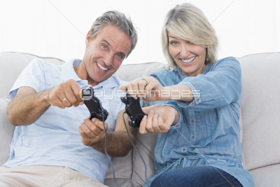 Couple using tablet together on the sofa