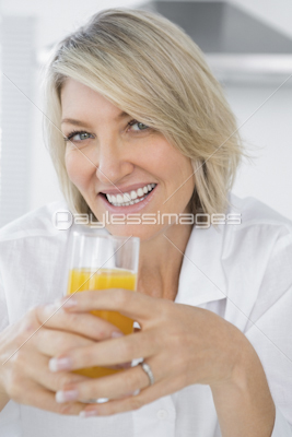 Happy woman eating cereal for breakfast