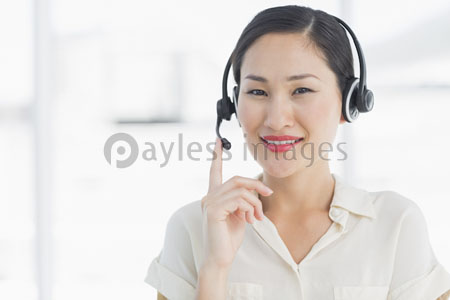 Management of the beautiful woman with a headset who smiles