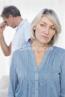 Man pleading with his wife after an argument