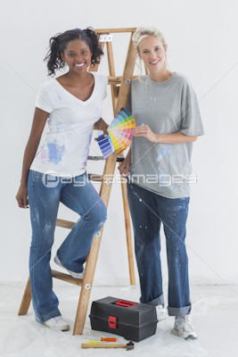 Pretty housemates choosing colour for wall