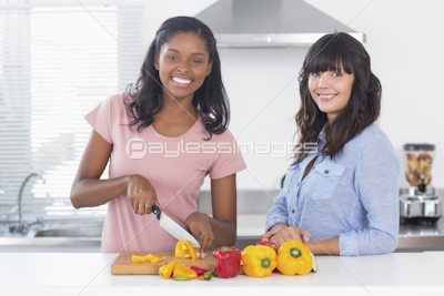 Smiling brunette with juicer full of fruit