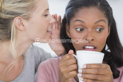 Smiling woman showing freshly baked cookies with friend