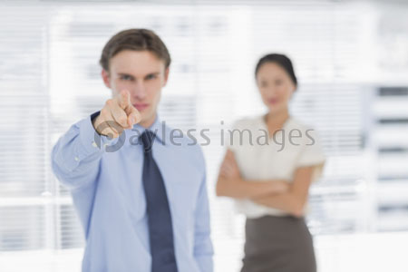The businessman points out office a woman and a camera.