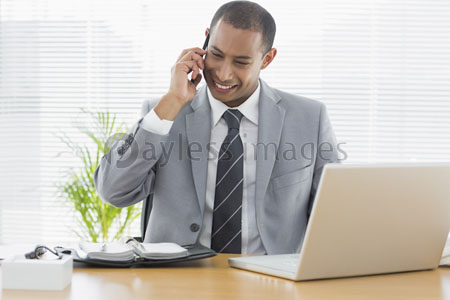 The businessman who used the mobile phone, smiled and had laptop is expressed.