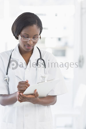 The female doctor is writing the report.