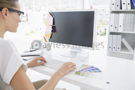 The female photo editor is tackling the computer.