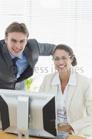 The sure business couple having a computer who smiles