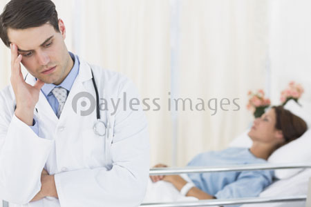 Worried doctor with the patient under hospitalization in a hospital