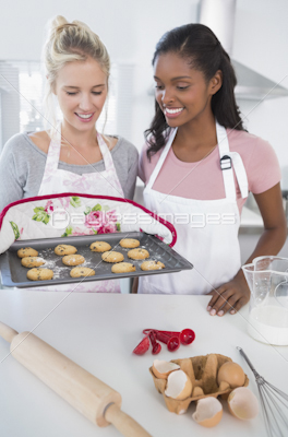 Young,friends,making,pastry,together,looking,at,camera