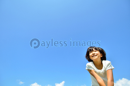 青空で見上げる女の子 商用利用可能な写真素材 イラスト素材ならストックフォトの定額制ペイレスイメージズ