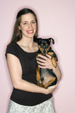 Woman+holding+Miniature+Pinscher+dog.