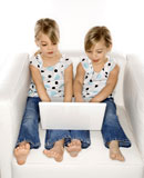 Girl+twins+with+laptop+computer.