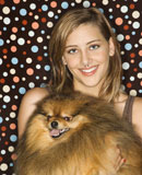 Teen+girl+holding+Pomeranian+dog.