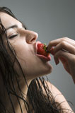 Woman+biting+strawberry.
