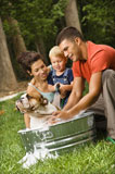 Family+giving+dog+a+bath.