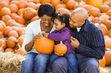 Family+holding+pumpkins.