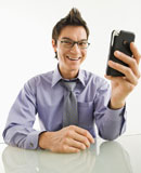 Smiling+businessman+with+cell+phone