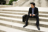 Businessman+sitting+on+steps