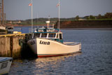 Fishing+boat+docked+at+a+pier+in+Prince+Edward+Island%2C+Canada