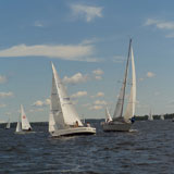 Sail+boats+sailing+in+a+Lake+of+the+woods%2C+Ontario%2C+Canada