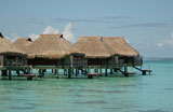 Thatched+buildings+on+stilts+built+in+the+sea%2C+Moorea%2C+Tahiti%2C+French+Polynesia%2C+South+Pacific