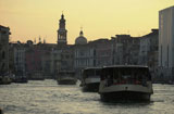 Passenger+boats+moving+in+a+canal+in+Venice%2C+Italy
