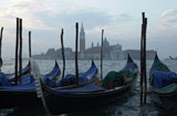 Array+of+gondolas+docked+at+a+canal+in+Venice%2C+Italy