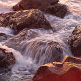 Water+flowing+over+rocks+at+shoreline