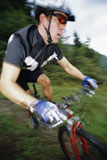 Man+outdoors+on+trails+riding+bicycle+%28out+of+focus%29