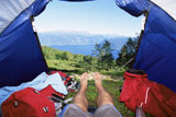 Man%27s+legs+in+a+tent+overlooking+scenic+location