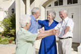 Two+senior+couples+greeting+each+other+with+open+arms