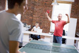 Two+men+in+office+space+playing+ping+pong