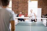 Man+and+woman+in+office+space+playing+ping+pong