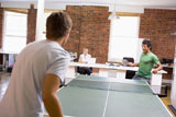 Two+men+in+office+space+playing+ping+pong