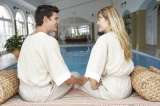 Young+Couple+Relaxing+By+Swimming+Pool