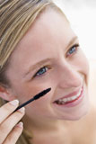 Woman+with+mascara+wand+smiling