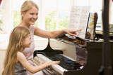 Woman+and+young+girl+playing+piano+and+smiling