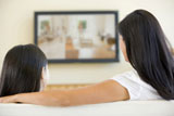 Woman+and+young+girl+in+living+room+with+flat+screen+television